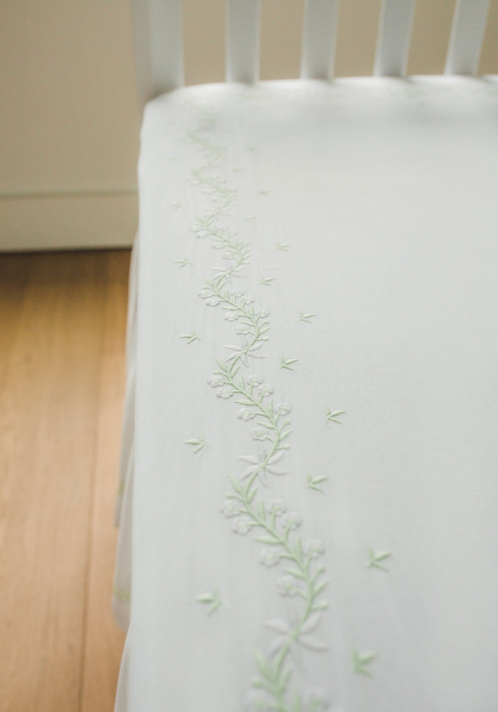 Little English classic nursery goods for baby, white crib sheet with simple light green embroidery along the edges for baby