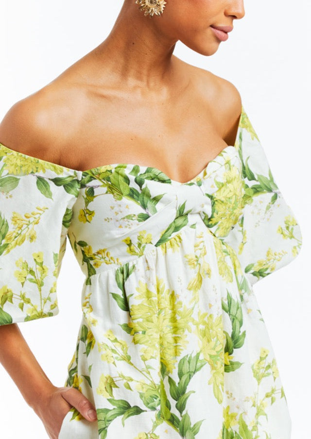 Floral printed midi dress with off-shoulder puff sleeves, sweetheart neckline, pockets, and smocking on back bodice. 