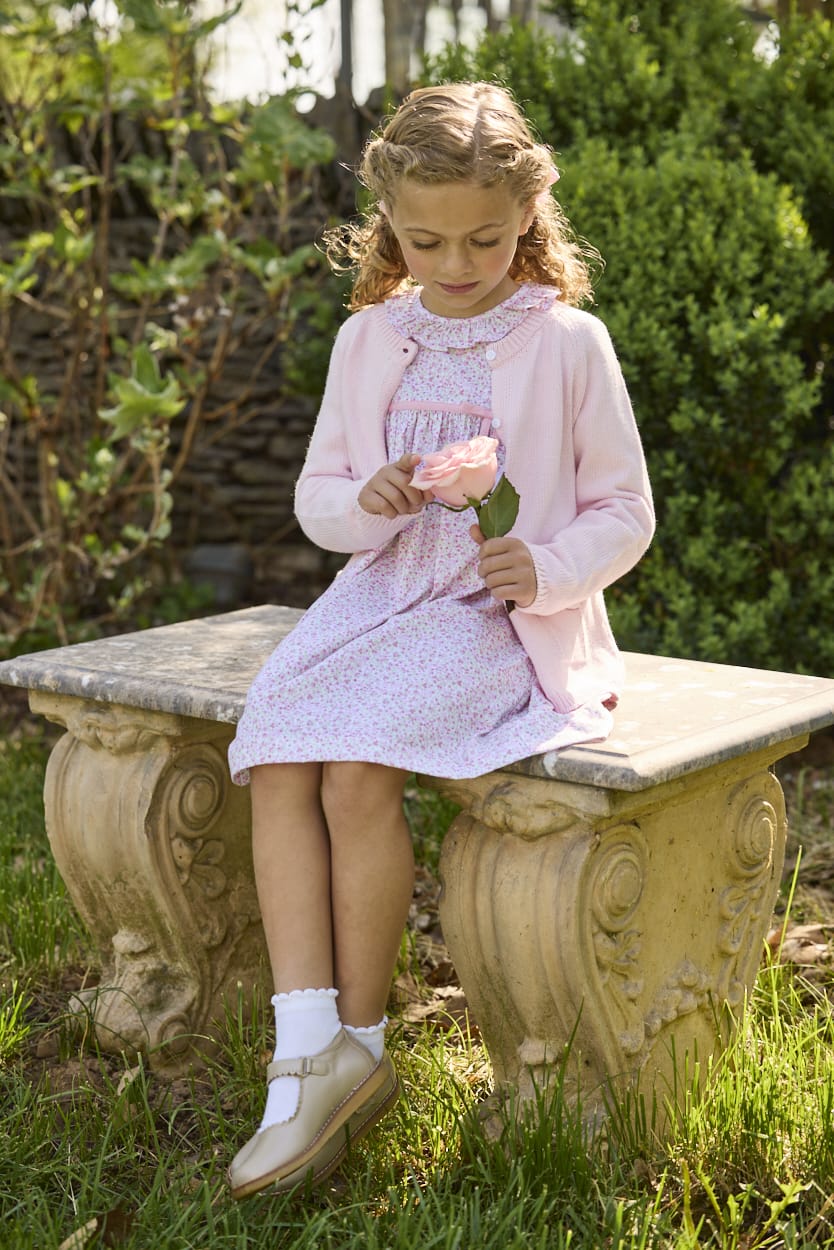 Little English traditional children's clothing. Long sleeve pink and green Windemere floral dress with ruffled collar and fixed bow detail for little girls.  Layered with light pink bow pocket cardigan.