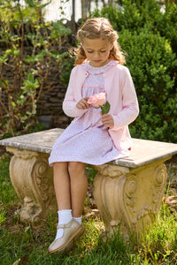 Little English traditional children's clothing. Long sleeve pink and green Windemere floral dress with ruffled collar and fixed bow detail for little girls.  Layered with light pink bow pocket cardigan.