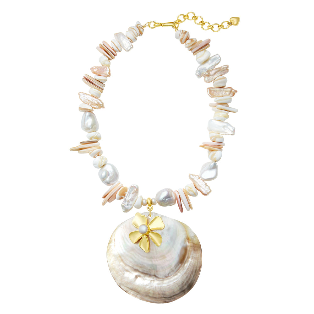 Flat lay of Emme Necklace with Tahitian oyster shell pendant, 24k antique gold plated flower and freshwater pearls on white