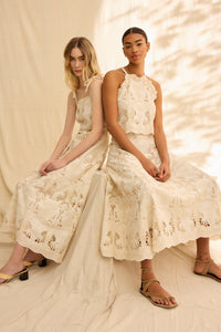 Cream embroidered top with a scallop hem