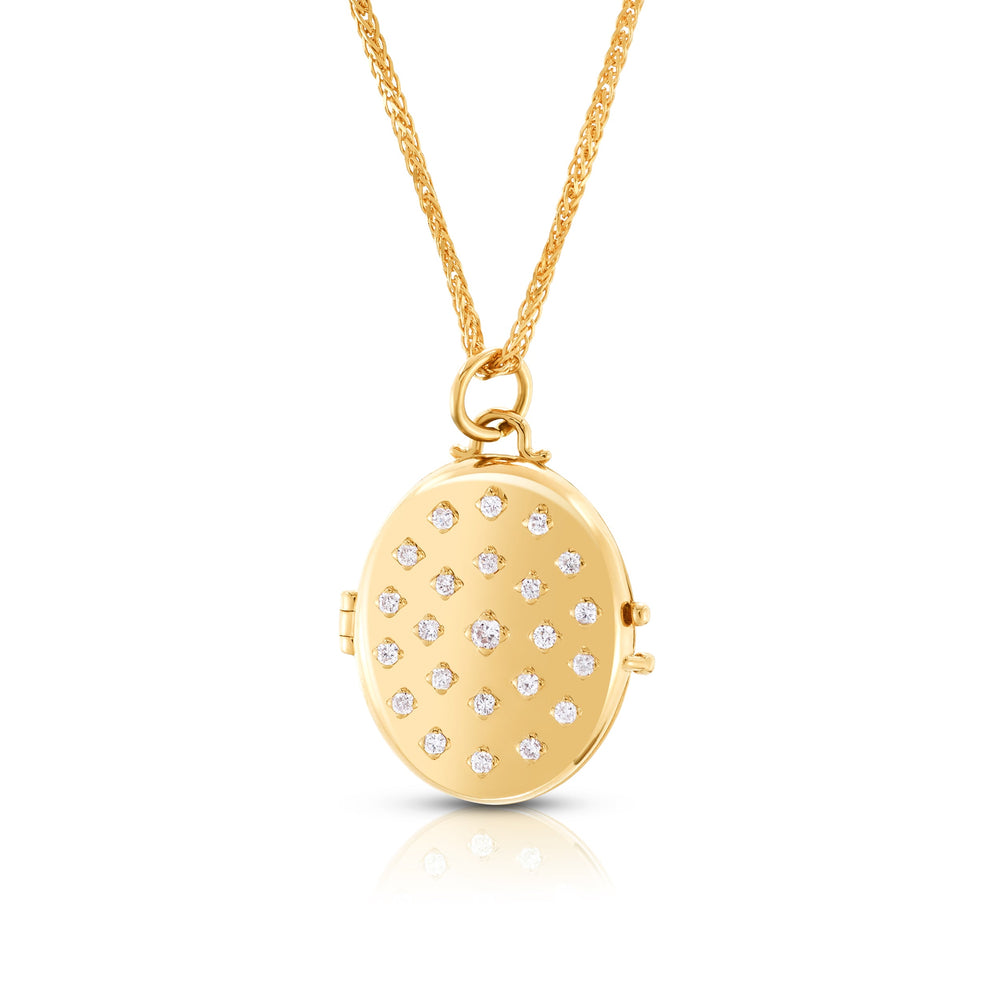 Front view of Etoile Locket, 14k yellow gold oval with scattered diamonds on a diamond-cut chain, white background