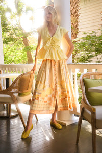 Eva Skirt in Still Life Symphony paired with Everly Top in Lemon Meringue, outside on porch.