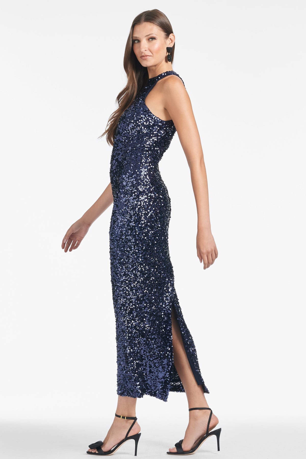 Front view of Meera Dress in Night Sky showcasing figure-hugging navy sequins and side slit on model