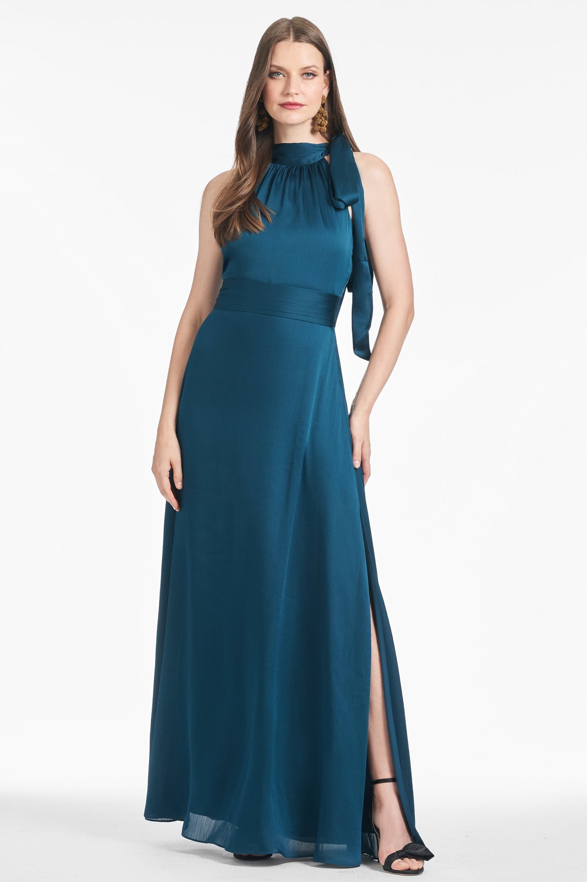 Front view of Kayla Gown in Bottle Green on a model, showcasing self tie neckline, pleated waistband, and maxi length