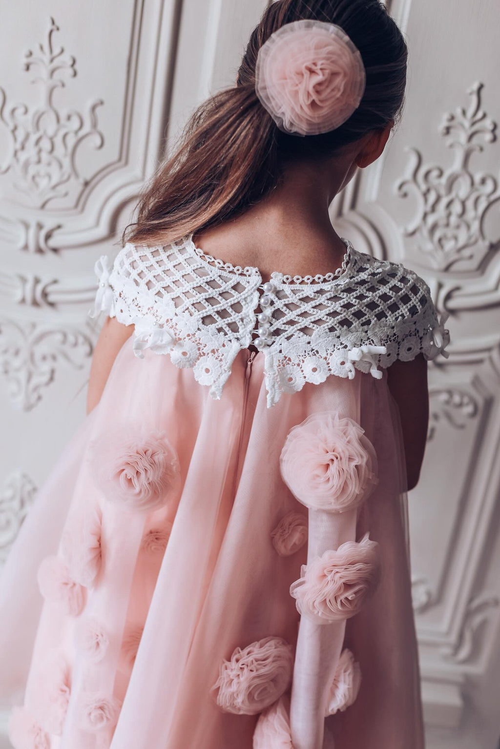 Back view of a girls pink tulle flower dress with lace bodice 