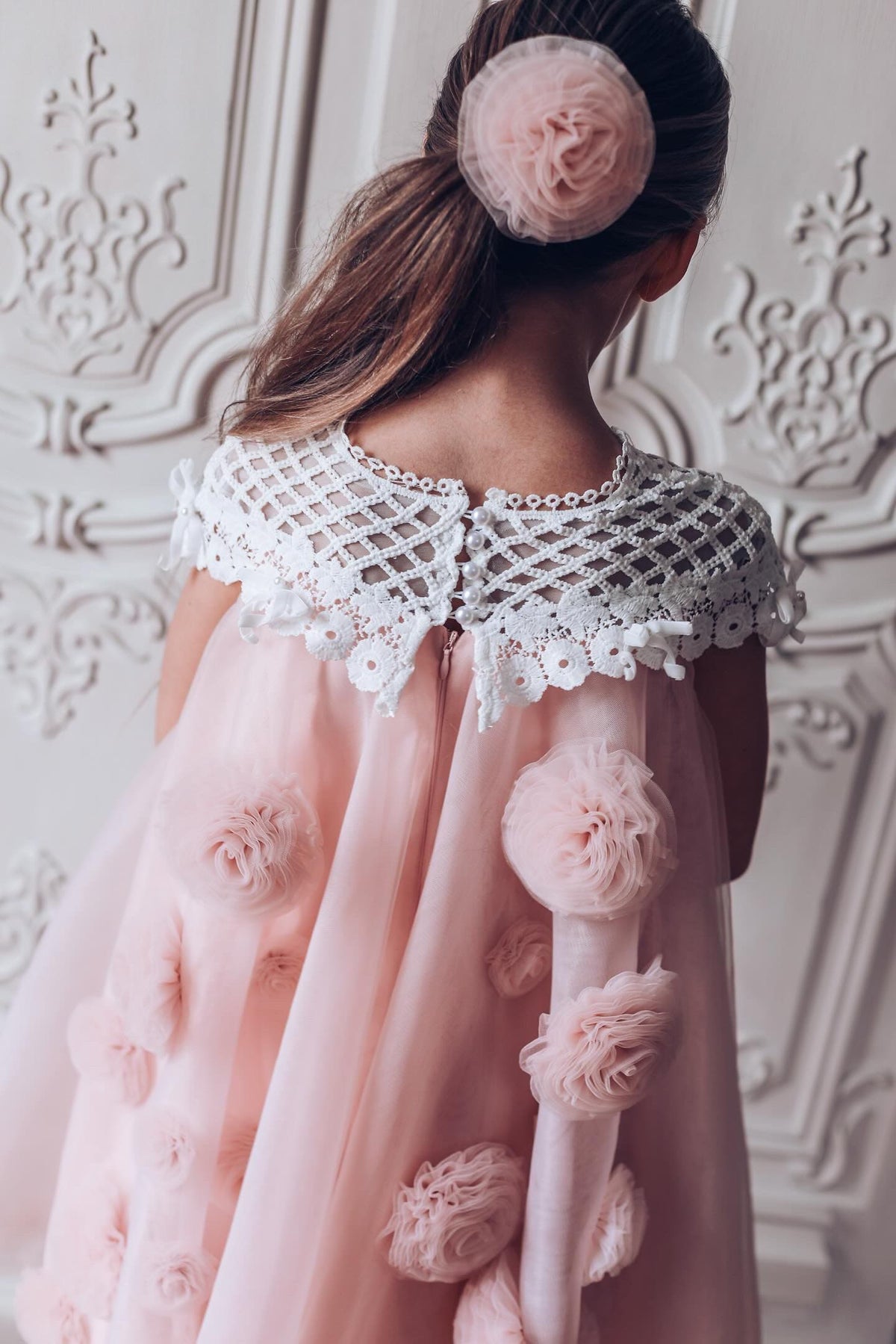 Back view of a girls pink tulle flower dress with lace bodice 