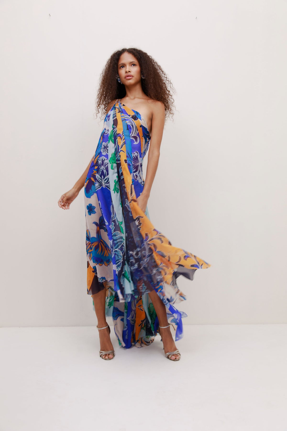 Front view of Iris Dress showcasing one shoulder silhouette and printed silk chiffon on a model against a light background