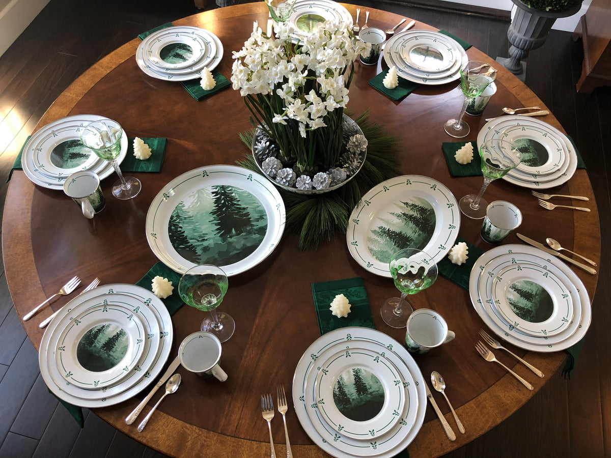 Overhead view of Sandwich Plates in Forest Glen, Set of 4 with forest tree designs and green trim on a dining table