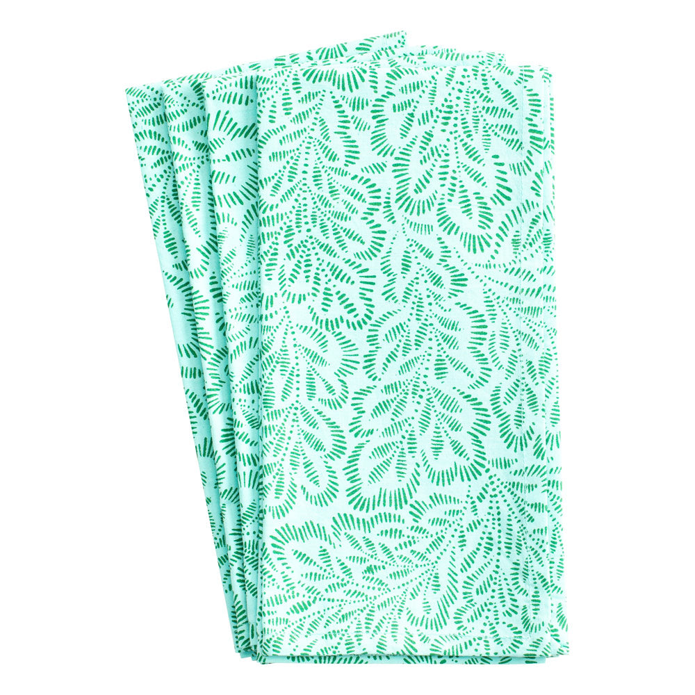 Folded view of Block Print Leaves dinner napkins set of four with turquoise and green leaf print on white background