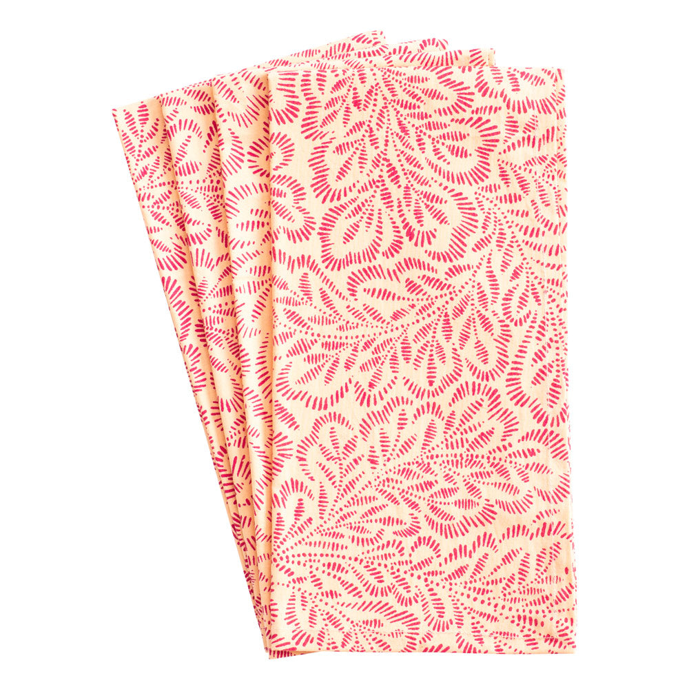 Front view of four Block Print Leaves napkins with coral and fuchsia leaf print on white background