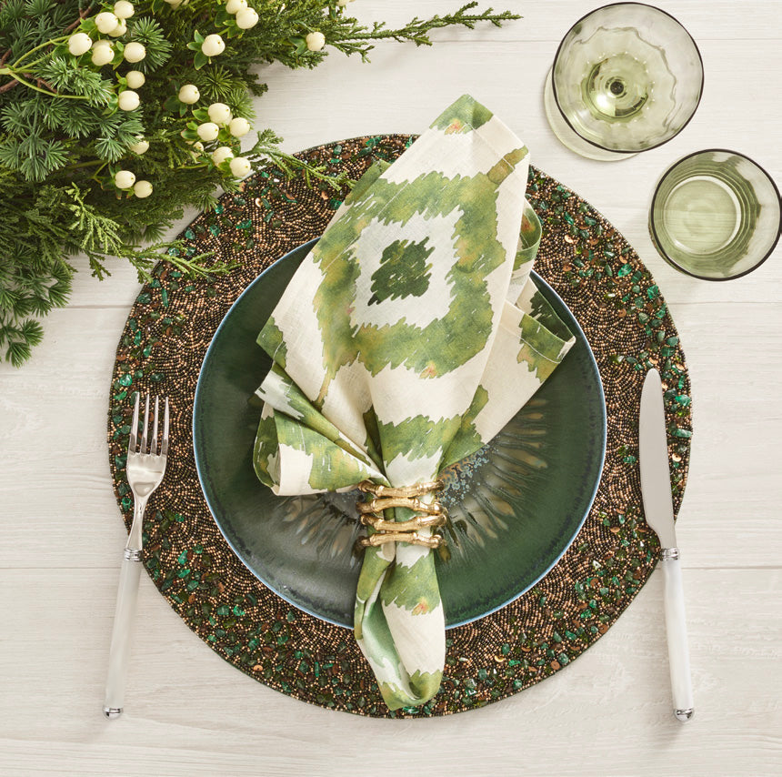 Top view of Watercolor Ikat Napkin in Olive, Set of 4 showcasing green Ikat pattern on a plated table setting