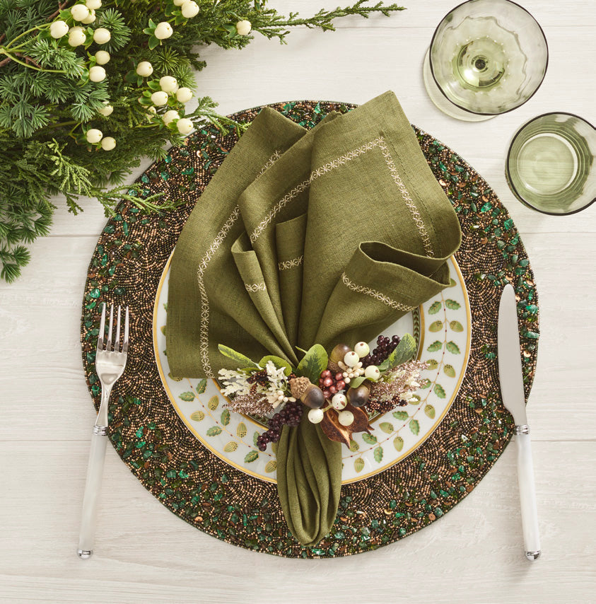 Overhead view of Wildwood Napkin Ring in Multi, set of 4, showcasing leaves and berries on a hand-beaded ring