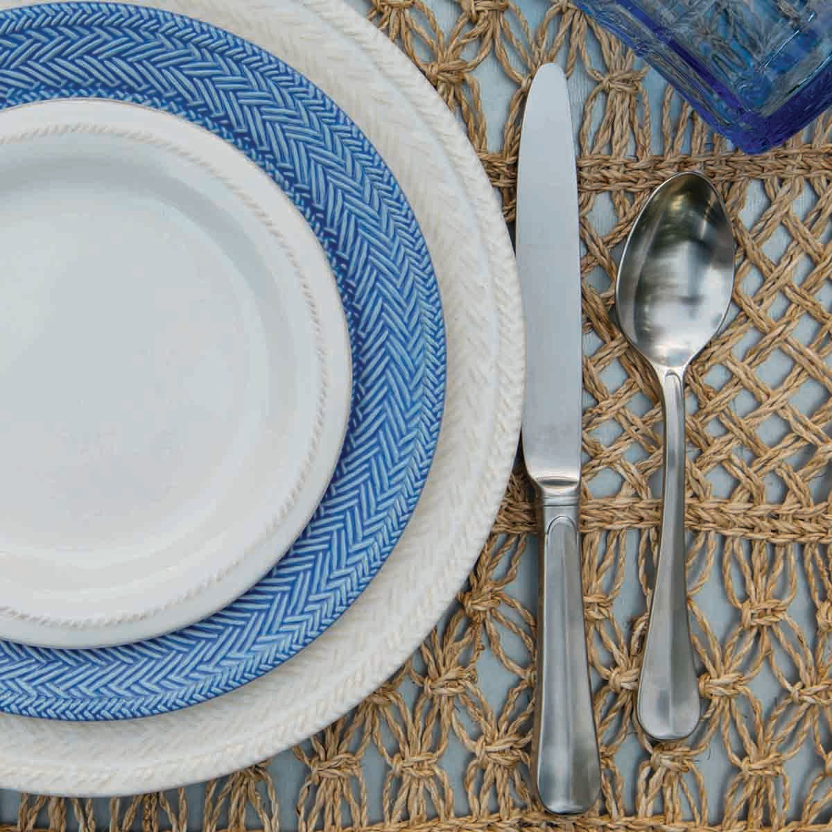 Close-up of Bistro 20-Piece Place Setting in Bright Satin with satin-finish flatware beside layered plates