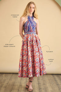 The Bellamy Dress is a criss cross halter dress with a full skirt and a clean side seam zipper.