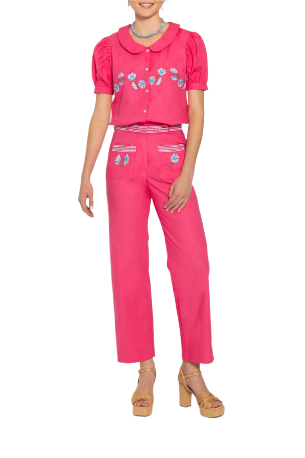 Front of Ahsen pant set, fuchsia crop button up top with puff sleeves and blue embroidery, high waist straight pants