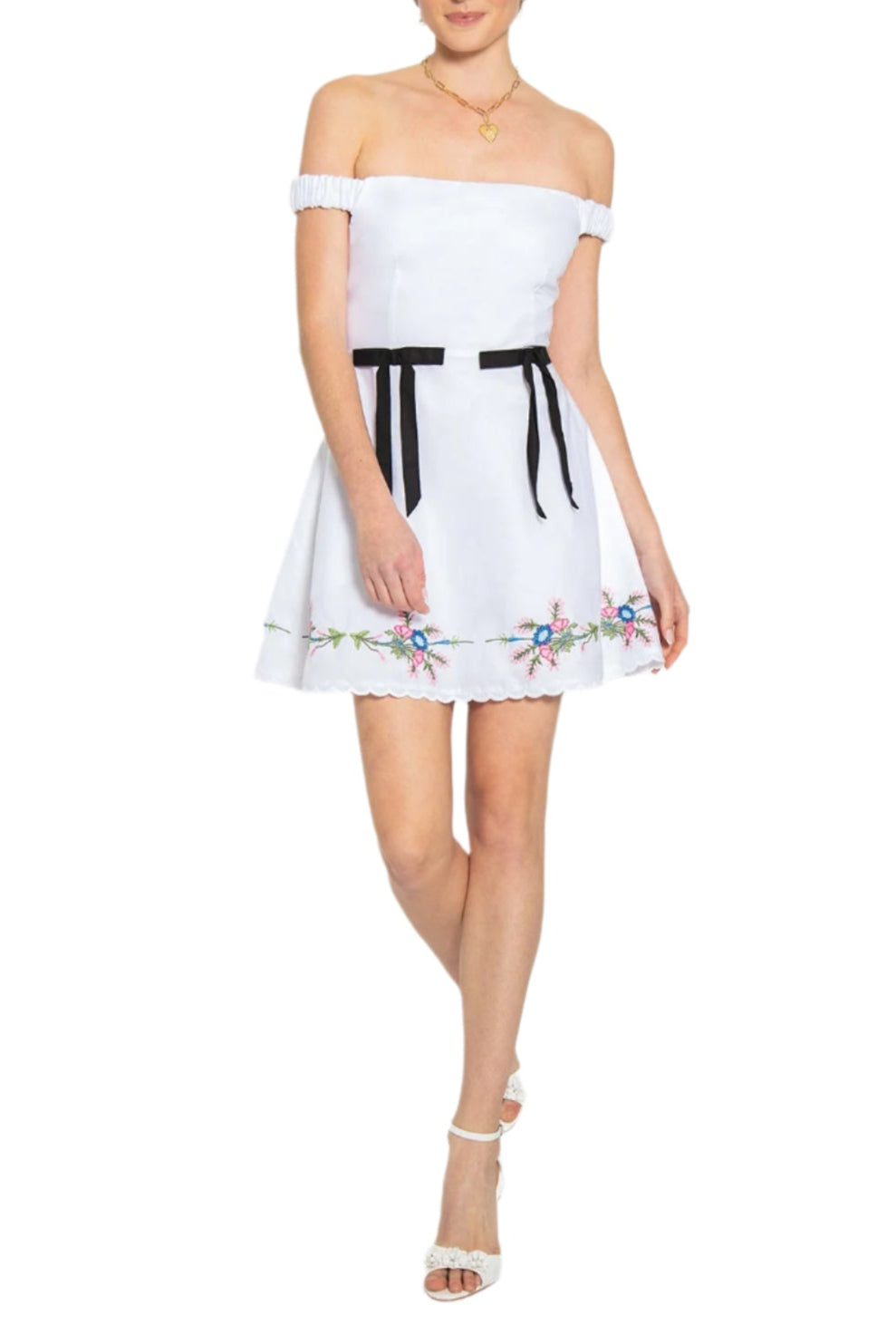 Front view of Aycan dress showcasing off-the-shoulder neckline, black waist ribbon ties, and floral embroidered scalloped hem on white background
