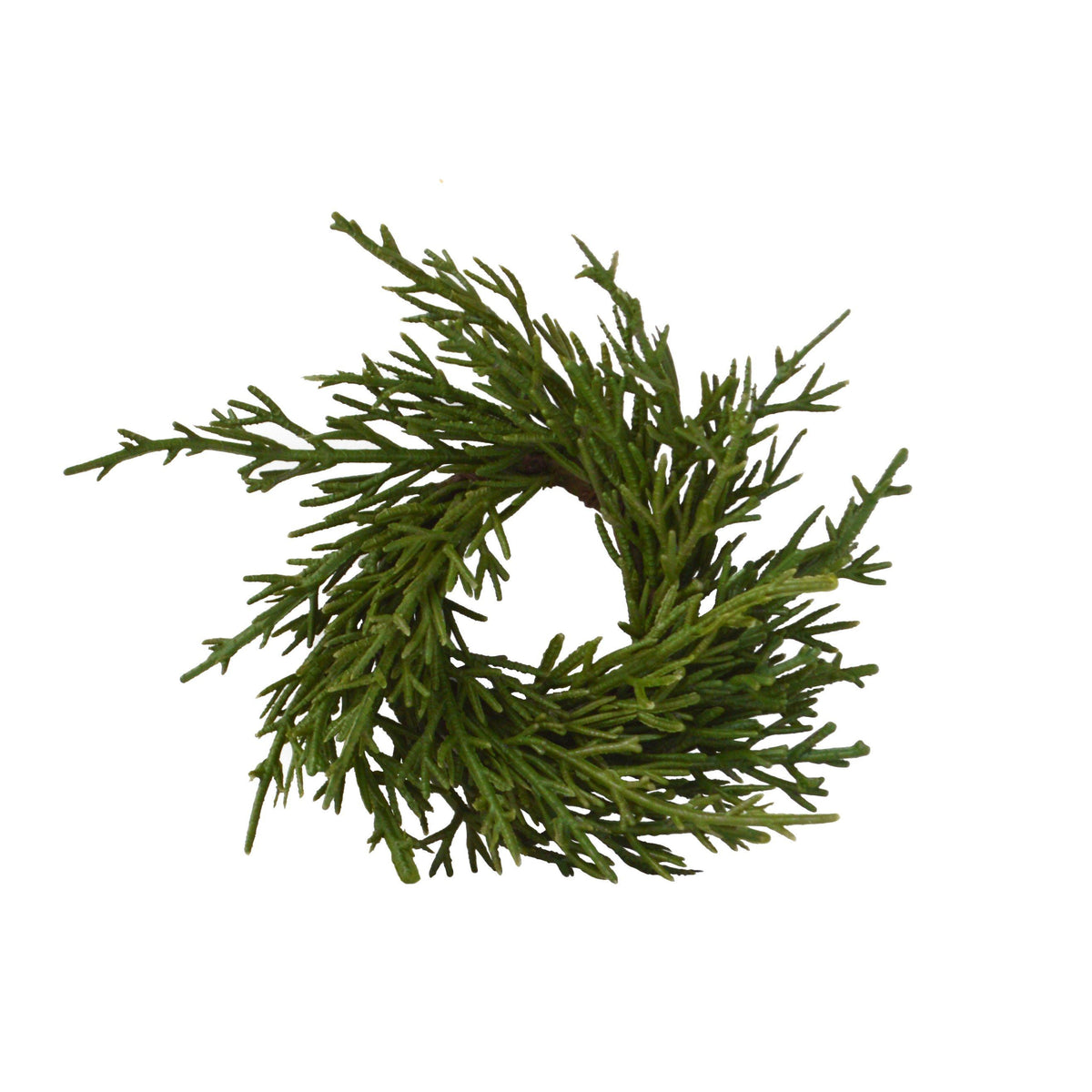 Top view of a faux fir napkin ring showing green artificial branches on a white background