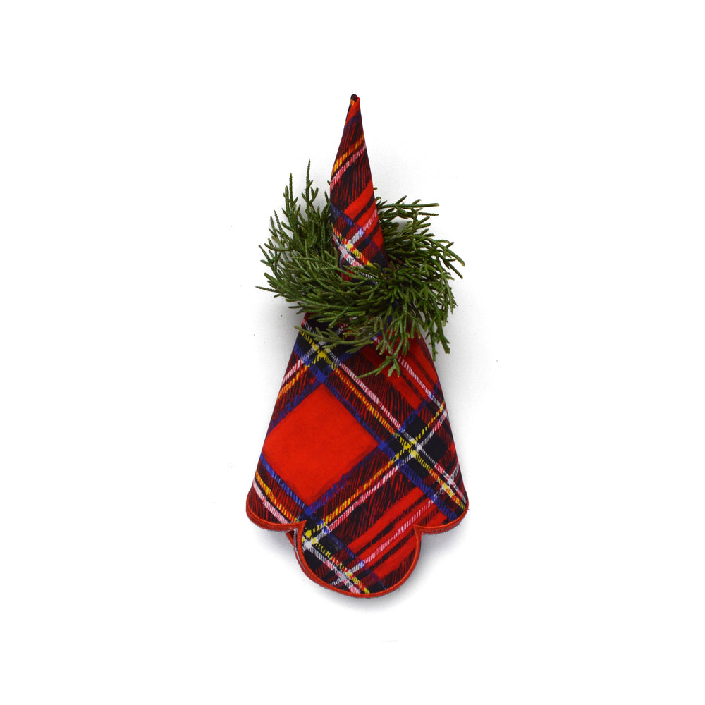 Angled top view of fir napkin ring (set of 4) showcasing faux evergreen sprigs on a folded red plaid napkin on white background