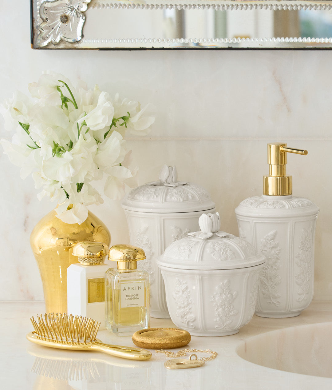 Front view of Josepha small ceramic canister showcasing embossed floral relief and rose topped lid on marble bathroom counter