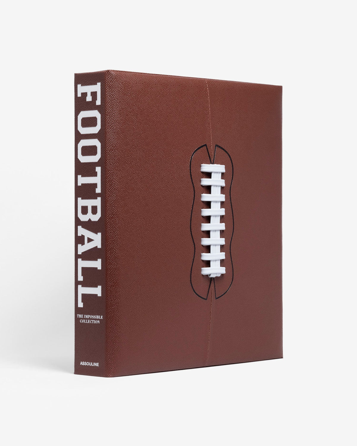 American Football: The Impossible Collection by Assouline: three-quarter angle view of the closed clamshell box; rich dark brown pebbled leather covers the box face and spine; a three-dimensional raised white football lace in relief is centered on the face; FOOTBALL in large white block type on the spine; THE IMPOSSIBLE COLLECTION and ASSOULINE in smaller white type below; white background