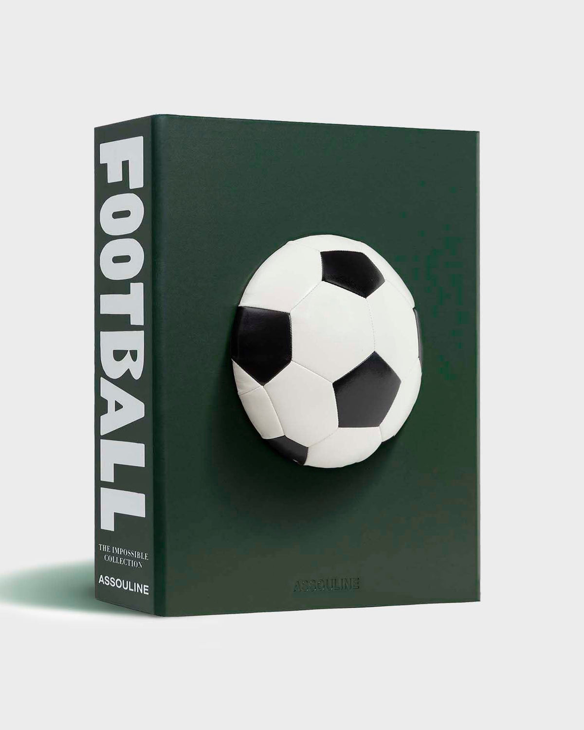 Football: The Impossible Collection by Assouline: three-quarter view of the slipcase; the dark forest green leather cover features a three-dimensional full-round black-and-white soccer ball mounted at center; FOOTBALL in large bold white condensed type on the spine; THE IMPOSSIBLE COLLECTION and ASSOULINE in smaller white type on the spine; ASSOULINE embossed at lower right of the face; white background