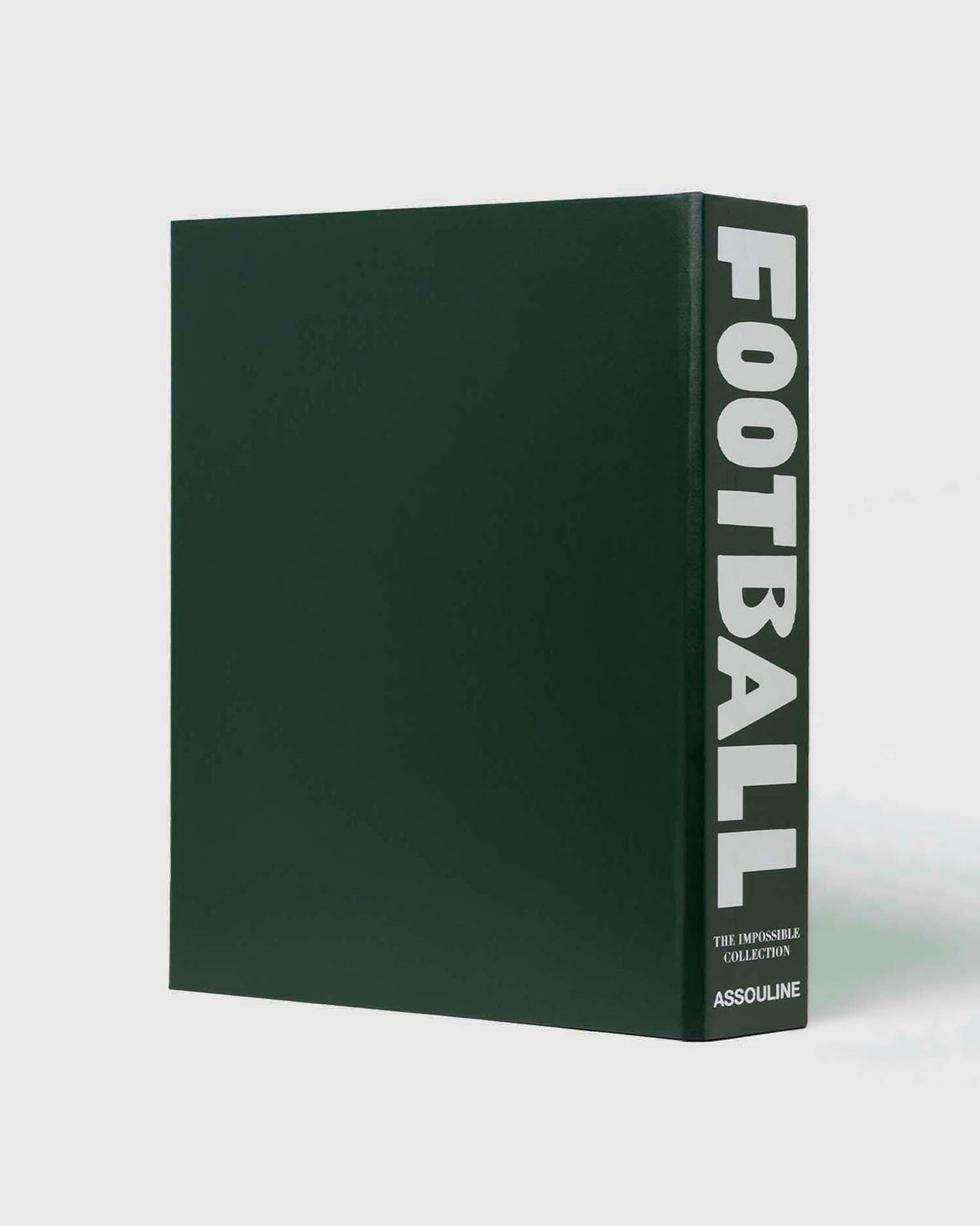 Football: The Impossible Collection by Assouline: three-quarter view of the plain back of the green leather slipcase; the dark forest green surface is completely unadorned; the spine at right reads FOOTBALL in bold white type, THE IMPOSSIBLE COLLECTION and ASSOULINE in smaller white type below; white background