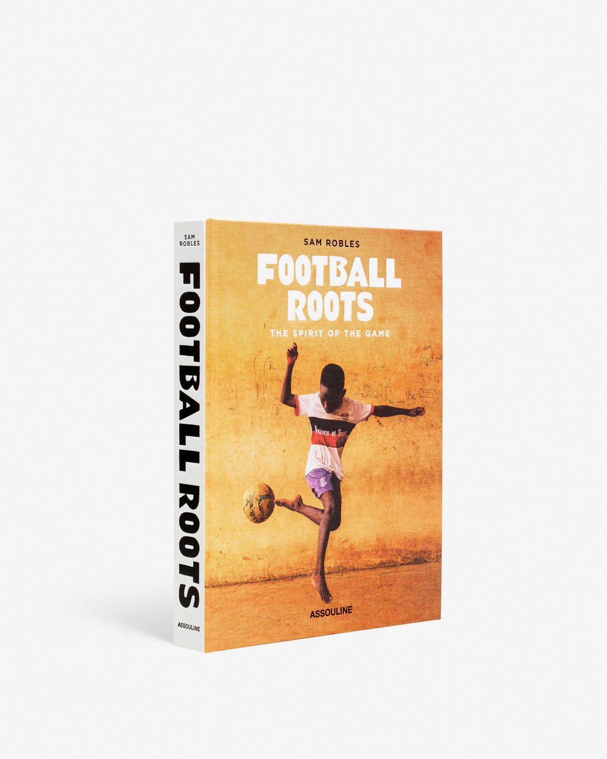Book titled 'Football Roots' with a soccer player on the cover against a yellow background