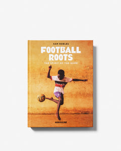 Book cover of 'Football Roots' with a person kicking a soccer ball on a yellow background