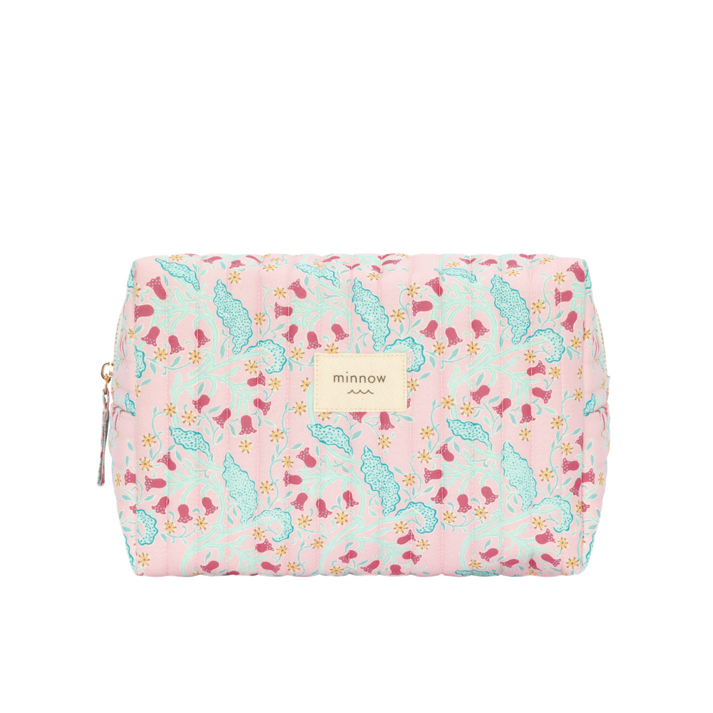 Front of Bluebells quilted travel pouch showing pink floral print, coated interior, and Minnow label on white
