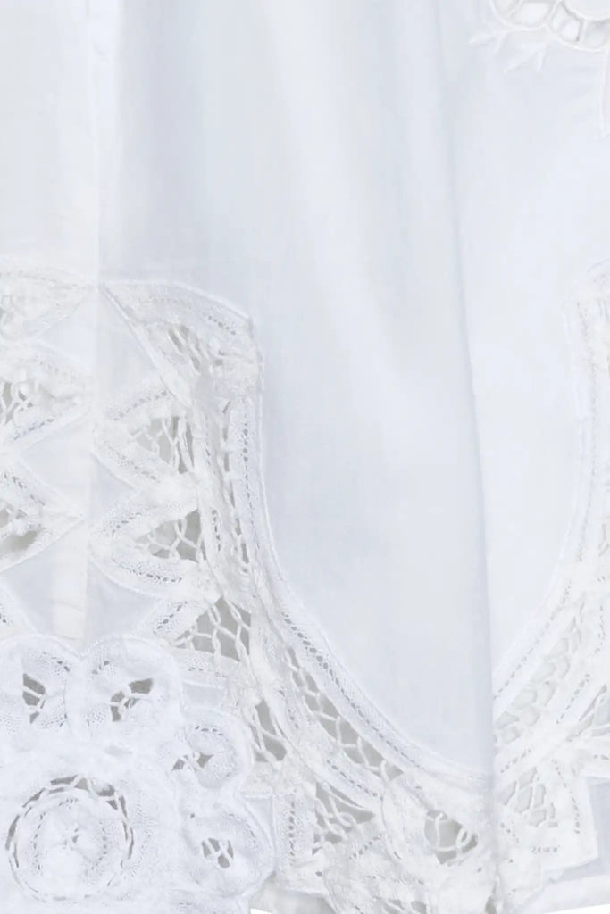 The Corrine Mini Skirt is in Battenberg white lace, clean waistband, and side-seam pockets.