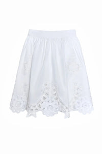 The Corrine Mini Skirt is in Battenberg white lace, clean waistband, and side-seam pockets.