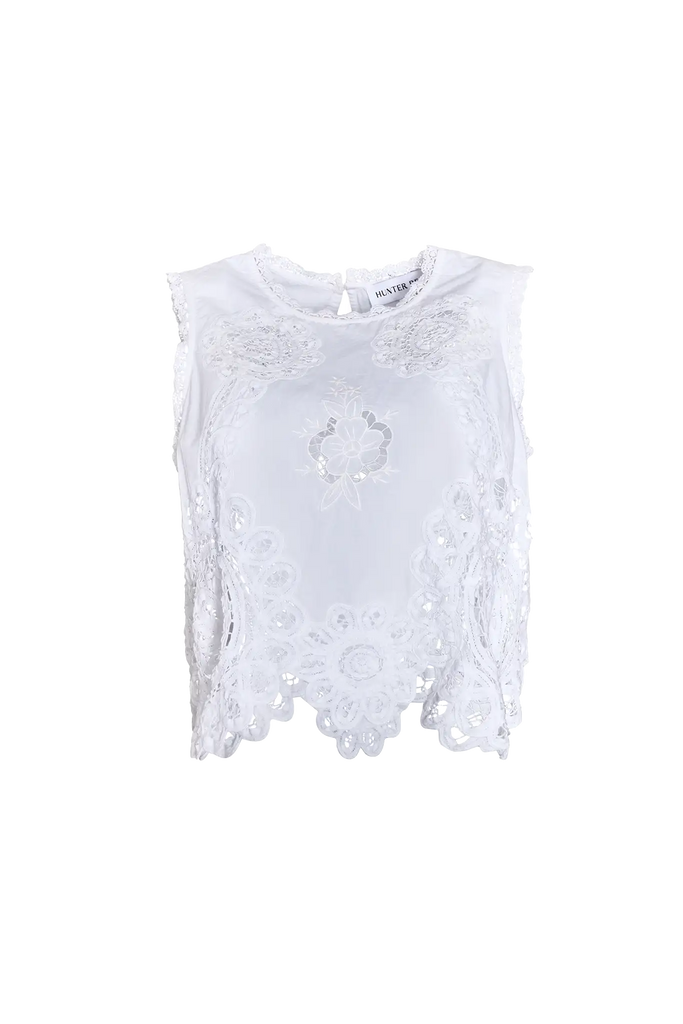 The Francesca Top in white lace has a cropped profile and sleeveless.