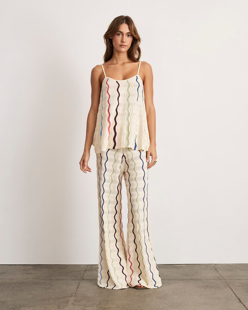 Model wearing Gigi Knit Tank in cream multi showing wavy crochet knit, square neckline and spaghetti straps on white