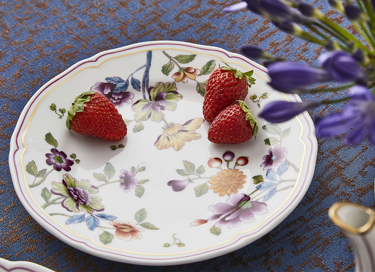 Top of Granduca Coreana dessert plate with multicolored peony floral pattern on white porcelain on blue tablecloth