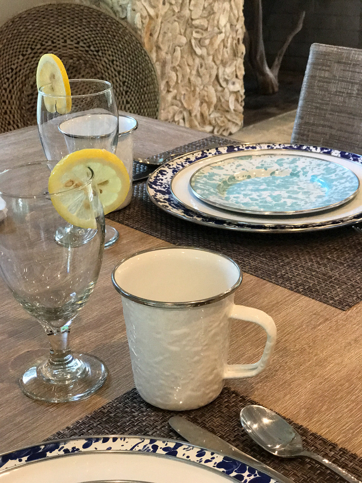 Close-up of Adult Mugs in Solid White, Set of 4 showing porcelain enamel and stainless steel trim on a dining table