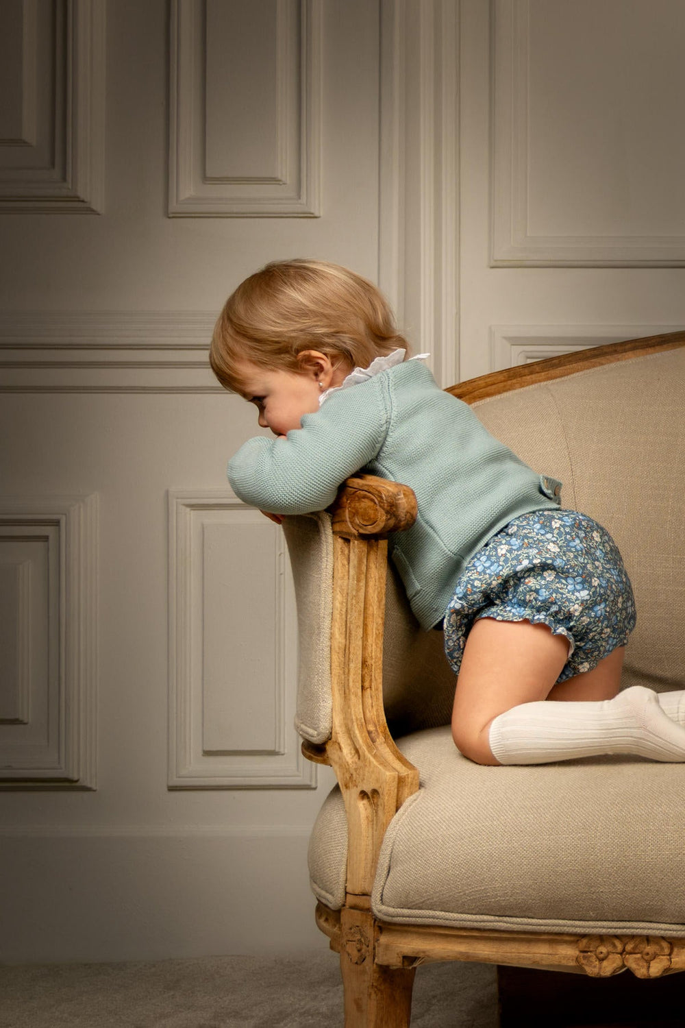Side view of Emma Bloomers in Twilight Bloom worn by a toddler, showing blue floral print and smocked waistband