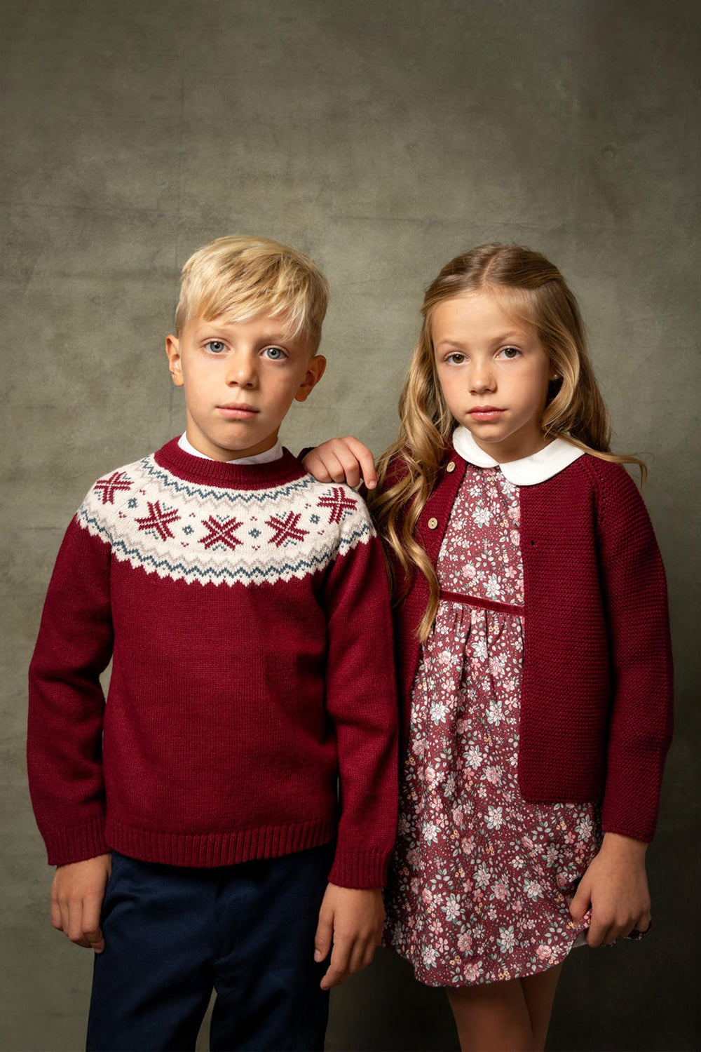 Front view of Jules Cardigan in Burgundy on a child model showcasing two-button front closure and textured knit with neutral backdrop