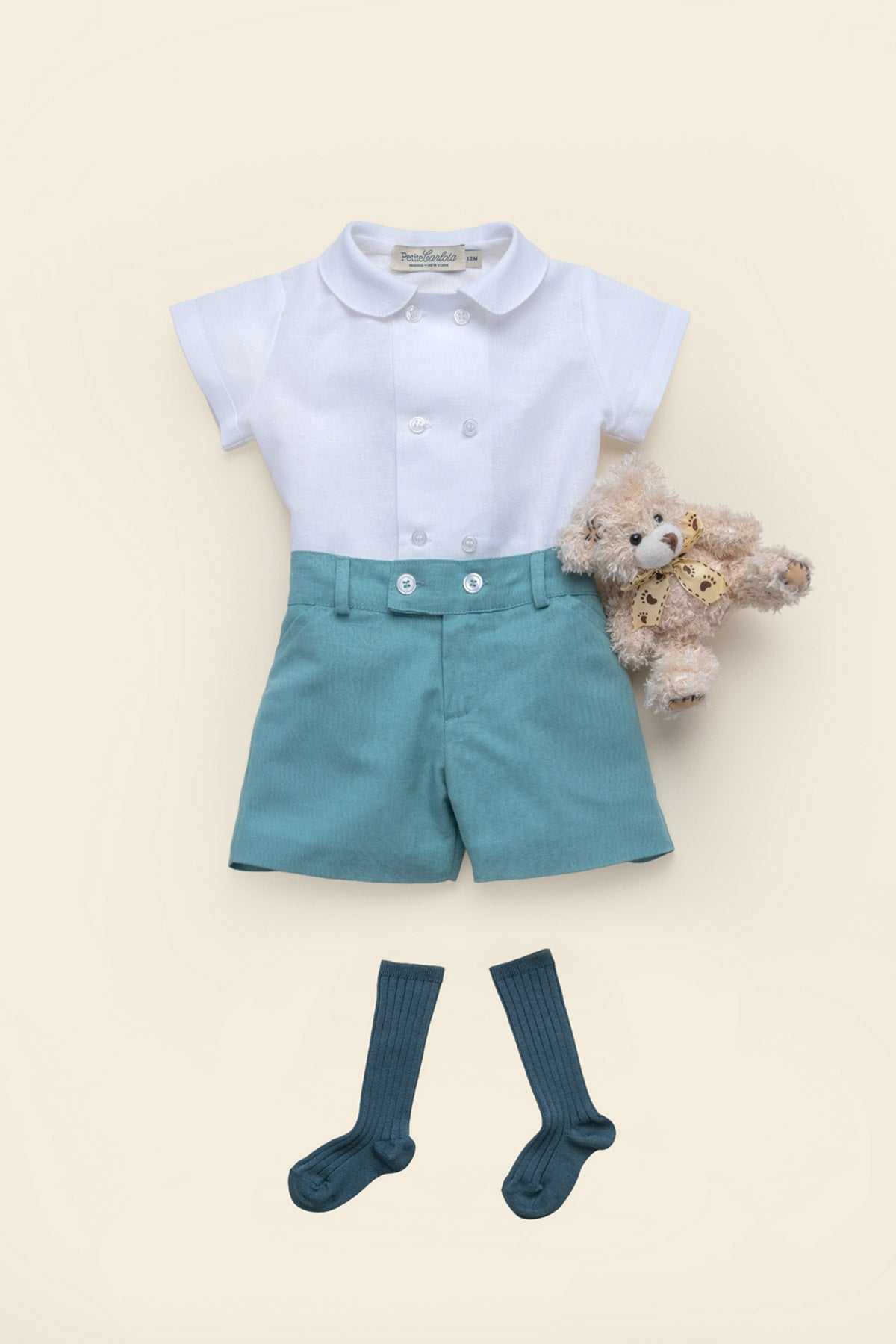 Front view of Sebastian linen shorts in mint with double-button waist, styled flat-lay with white shirt and navy socks