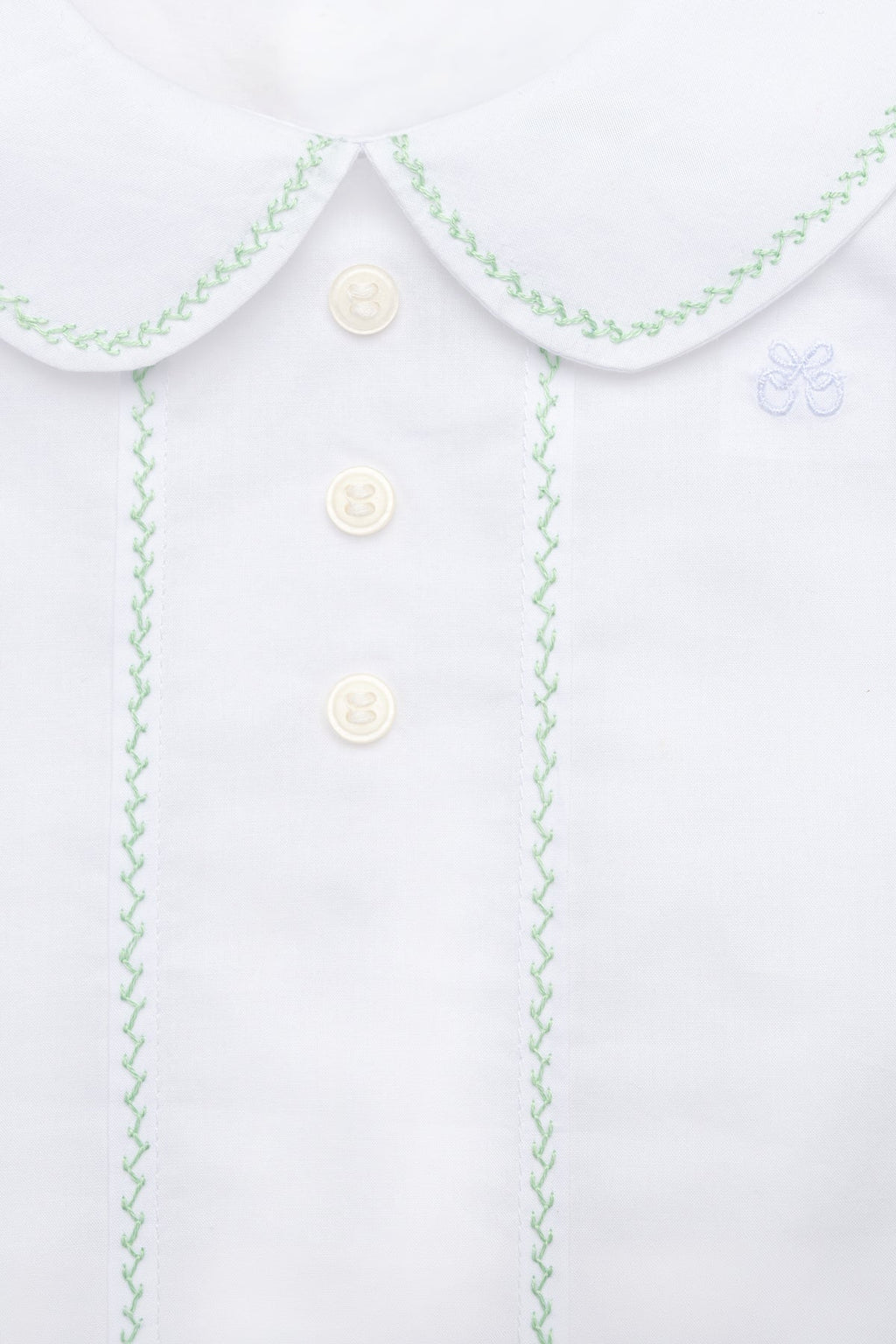 Close-up front of Eduardo Shirt in Olive showcasing Peter Pan collar and herringbone embroidery with buttons on a plain background