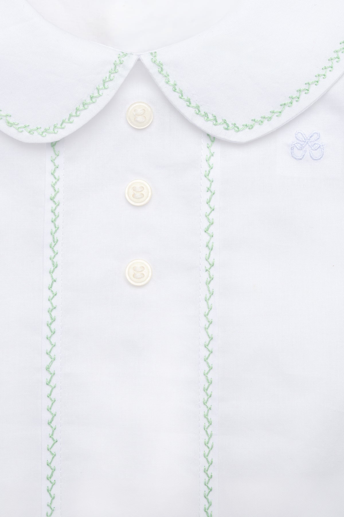 Close-up front of Eduardo Shirt in Olive showcasing Peter Pan collar and herringbone embroidery with buttons on a plain background