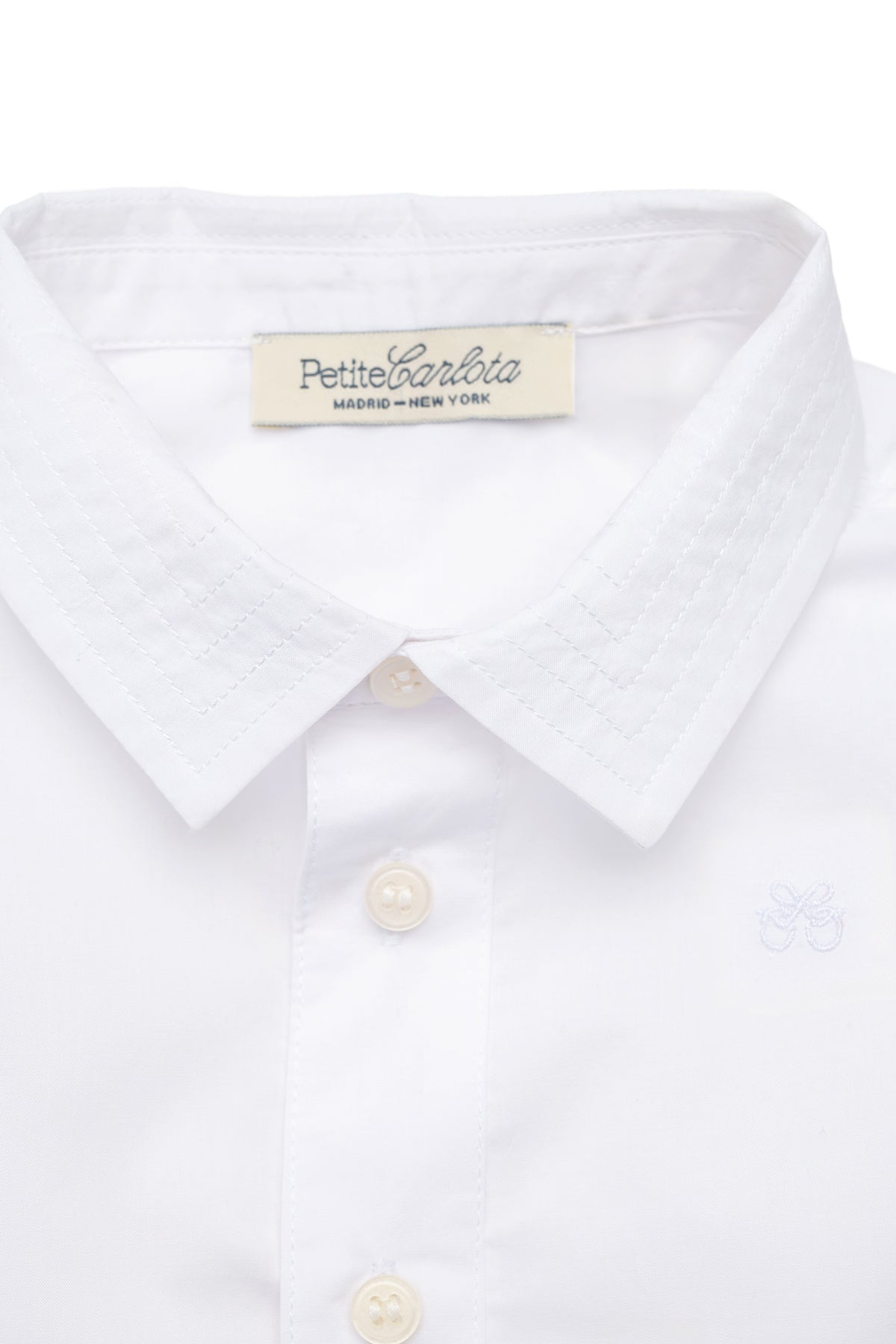 Close-up front view of Enrique Shirt in Cloud White showcasing stitched collar and button-down front on a white background