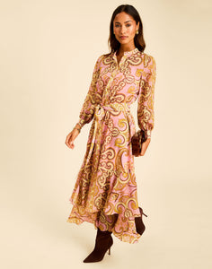 Gaia Maxi Dress in Gilded Florentina with a mandarin collar, long sleeves, tie belt, and ruffled hem.
