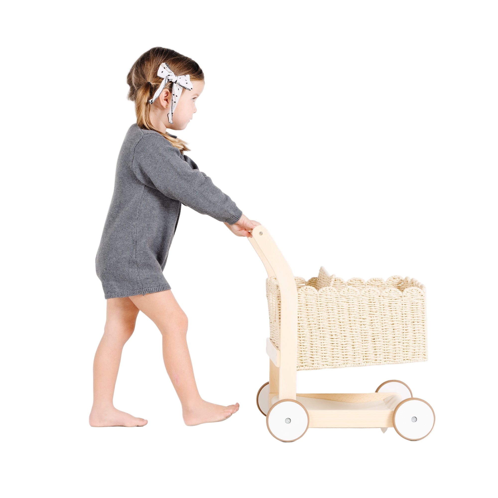 Ivory@little girl playing with shopping trolley
