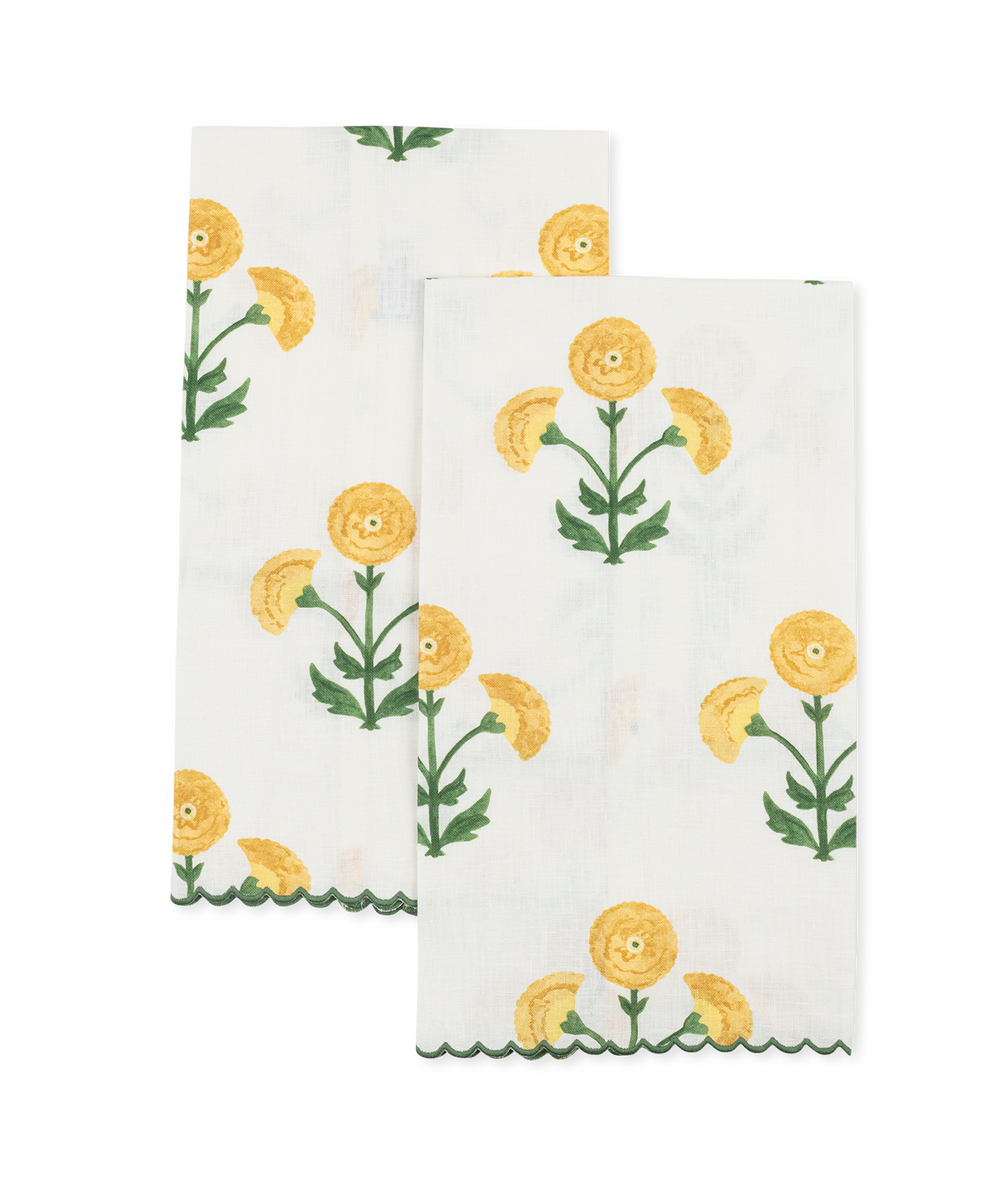 Front view of Gisele guest towels, set of two showcasing marigold floral print on white linen with scalloped green edge