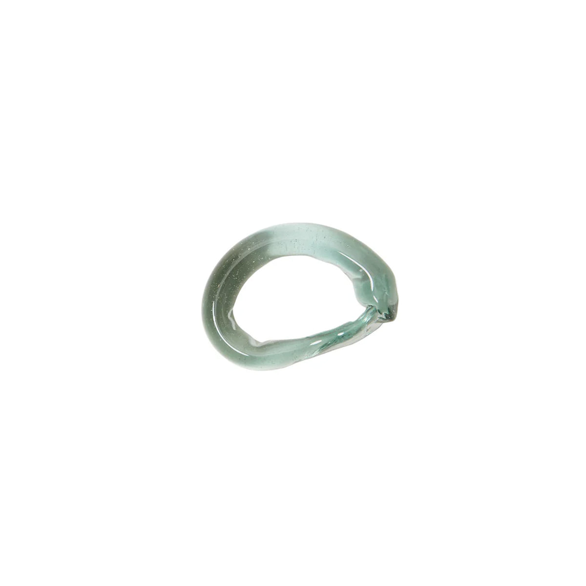 Top-down view of twisted handblown glass napkin ring showing twisted texture and seafoam green tint on white background