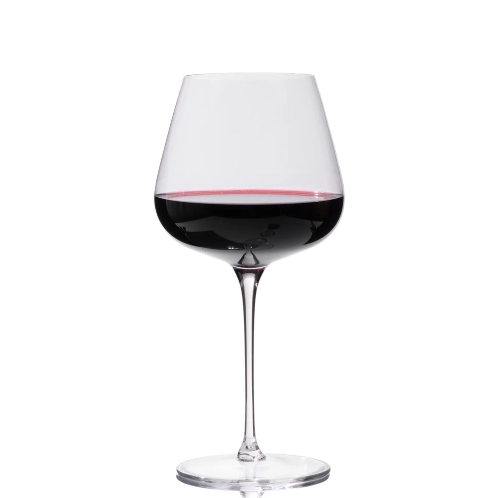 Front view of a red wine glass with red wine showing ultra-thin laser-cut rim and clear crystal on white background