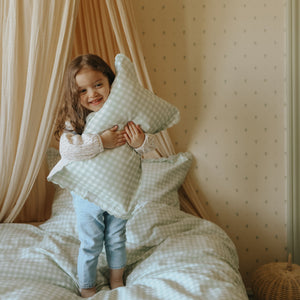 Picnic Gingham Green Toddler Pillow in little girls arms standing on top of bed