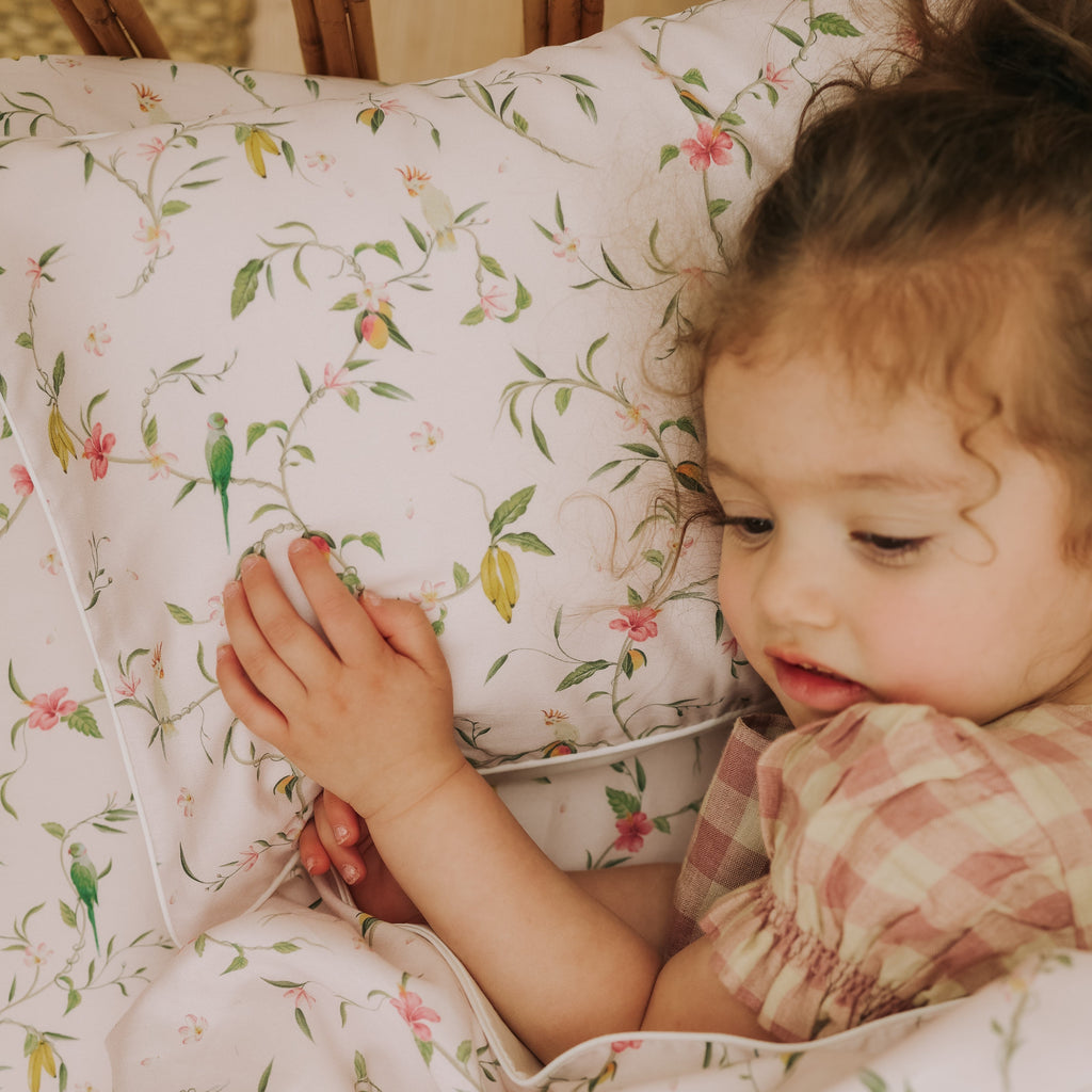 Dreaming of Paradise Toddler Pillow  with little girl laying cozy in bed